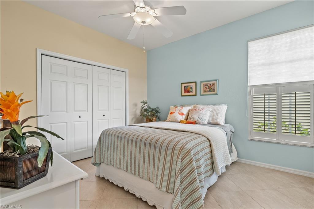 23164 Grassy Pine Drive Estero, FL 33928 - Photo 22 of 43 a bedroom with a bed and a chandelier