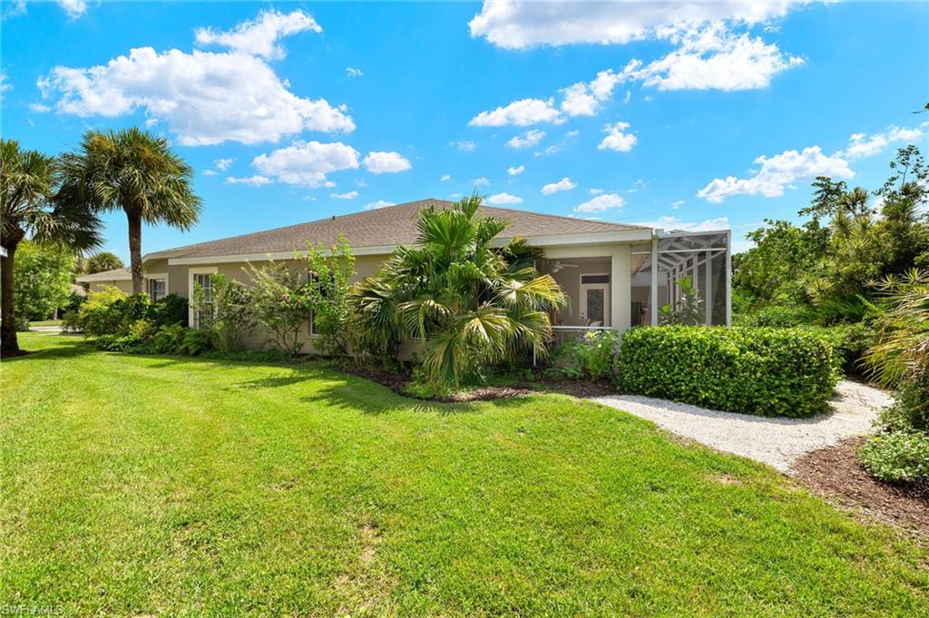 23164 Grassy Pine Drive Estero, FL 33928 - Photo 29 of 43 a view of a house with a big yard and potted plants