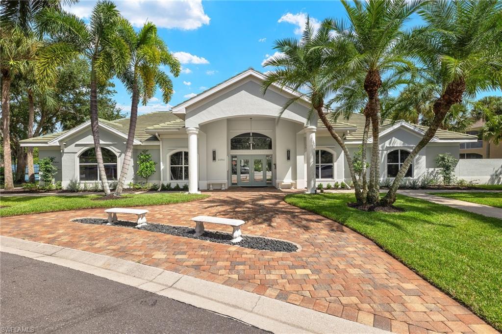 23164 Grassy Pine Drive Estero, FL 33928 - Photo 30 of 43 a front view of a house with a garden