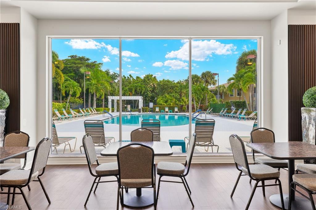 23164 Grassy Pine Drive Estero, FL 33928 - Photo 33 of 43 a dining room with furniture and a floor to ceiling window