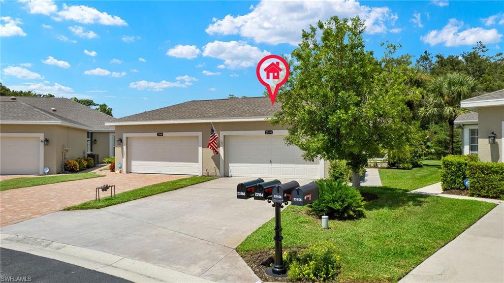 23164 Grassy Pine Drive Estero, FL 33928 - Photo 39 of 43 a front view of a house with a yard and garage