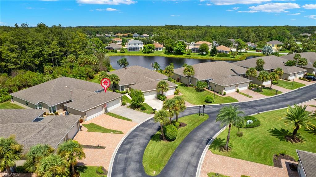 23164 Grassy Pine Drive Estero, FL 33928 - Photo 42 of 43 an aerial view of a house with a swimming pool lake and mountain view