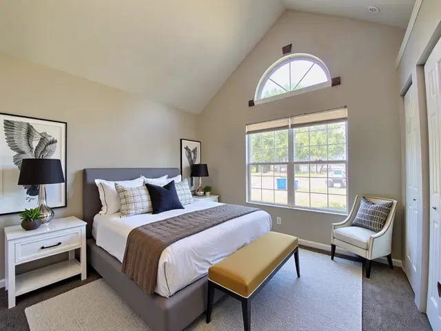 a bedroom with a bed and a couch