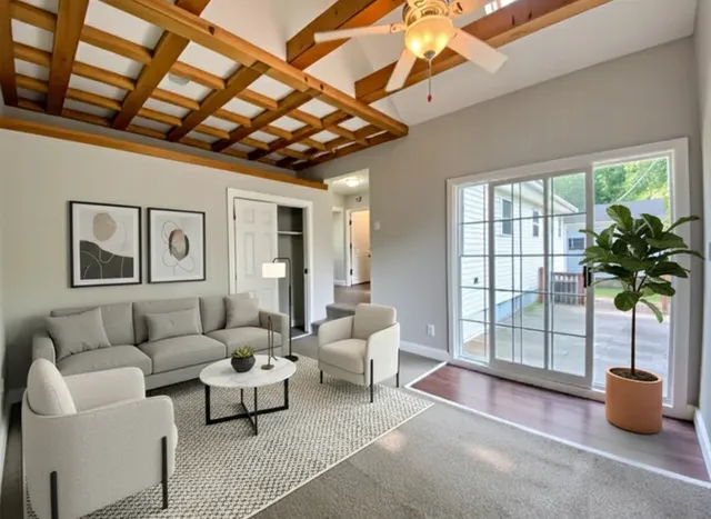 a living room with furniture and a potted plant