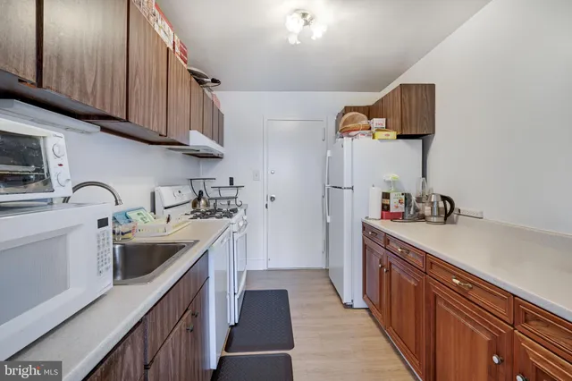 a kitchen with granite countertop a sink and cabinets