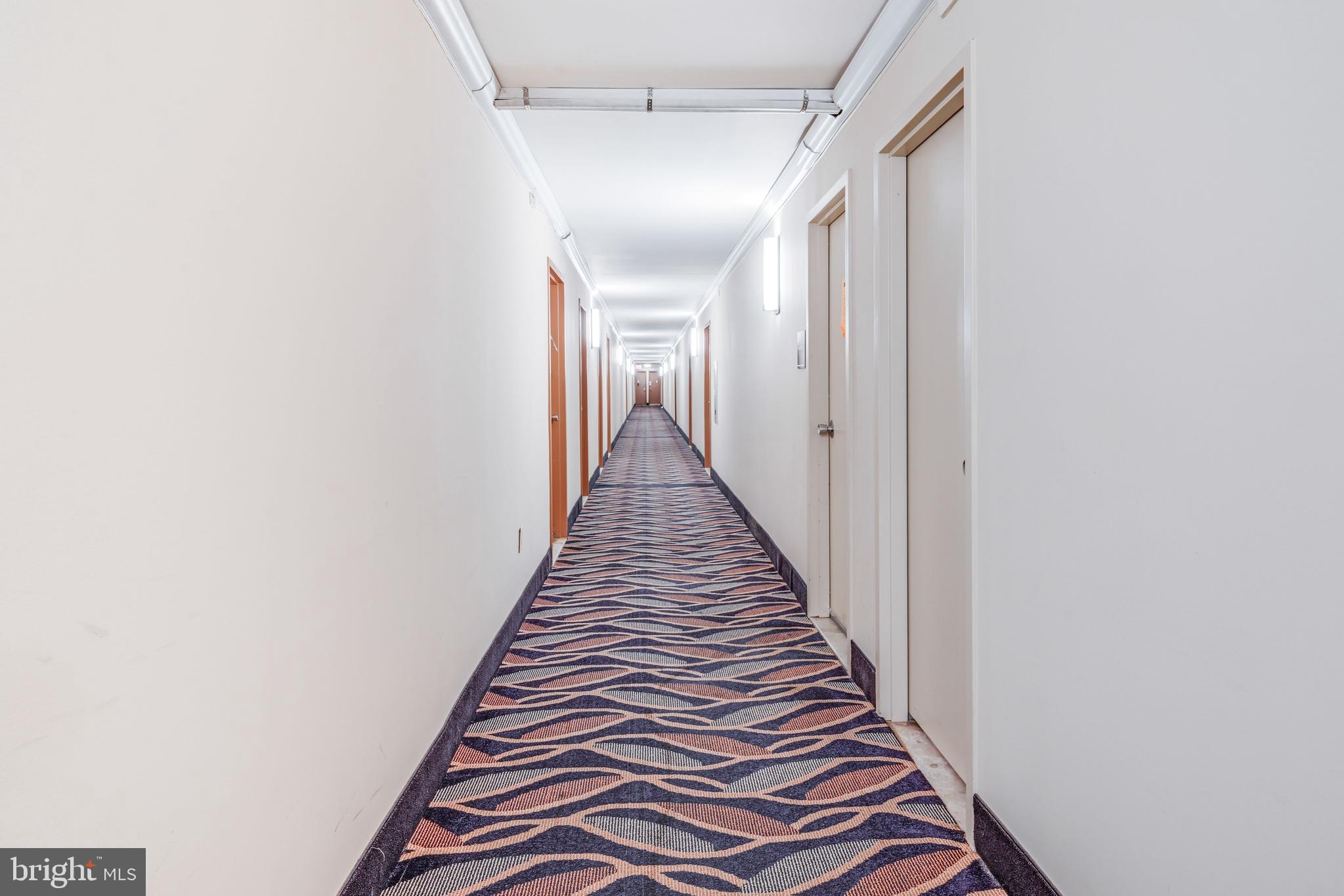 1111 University Boulevard West, Unit 611A Silver Spring, MD 20902 - Photo 16 of 26 a view of a hallway with wooden floor