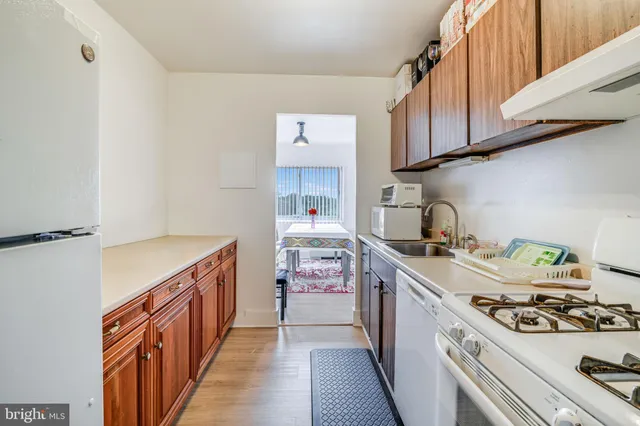 a kitchen with a stove and a white cabinets