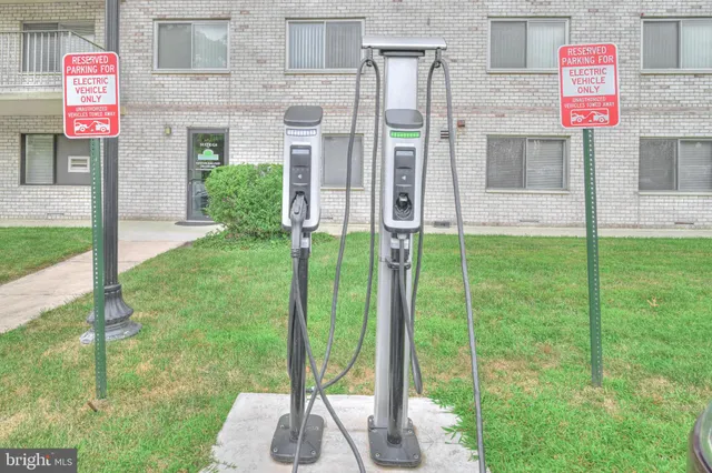 a front view of a house with a garden and plants