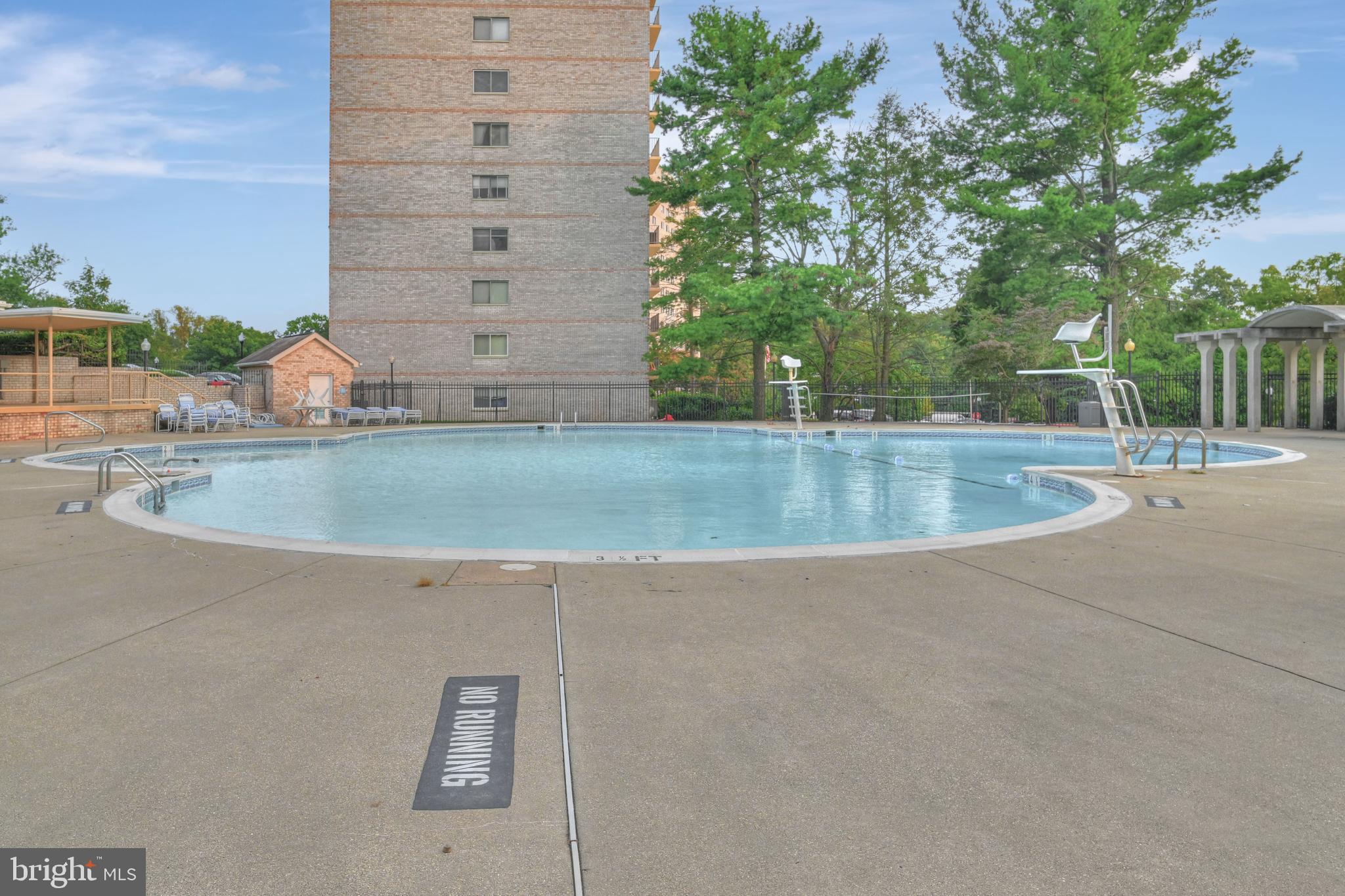 1111 University Boulevard West, Unit 611A Silver Spring, MD 20902 - Photo 23 of 26 a view of a swimming pool with a yard