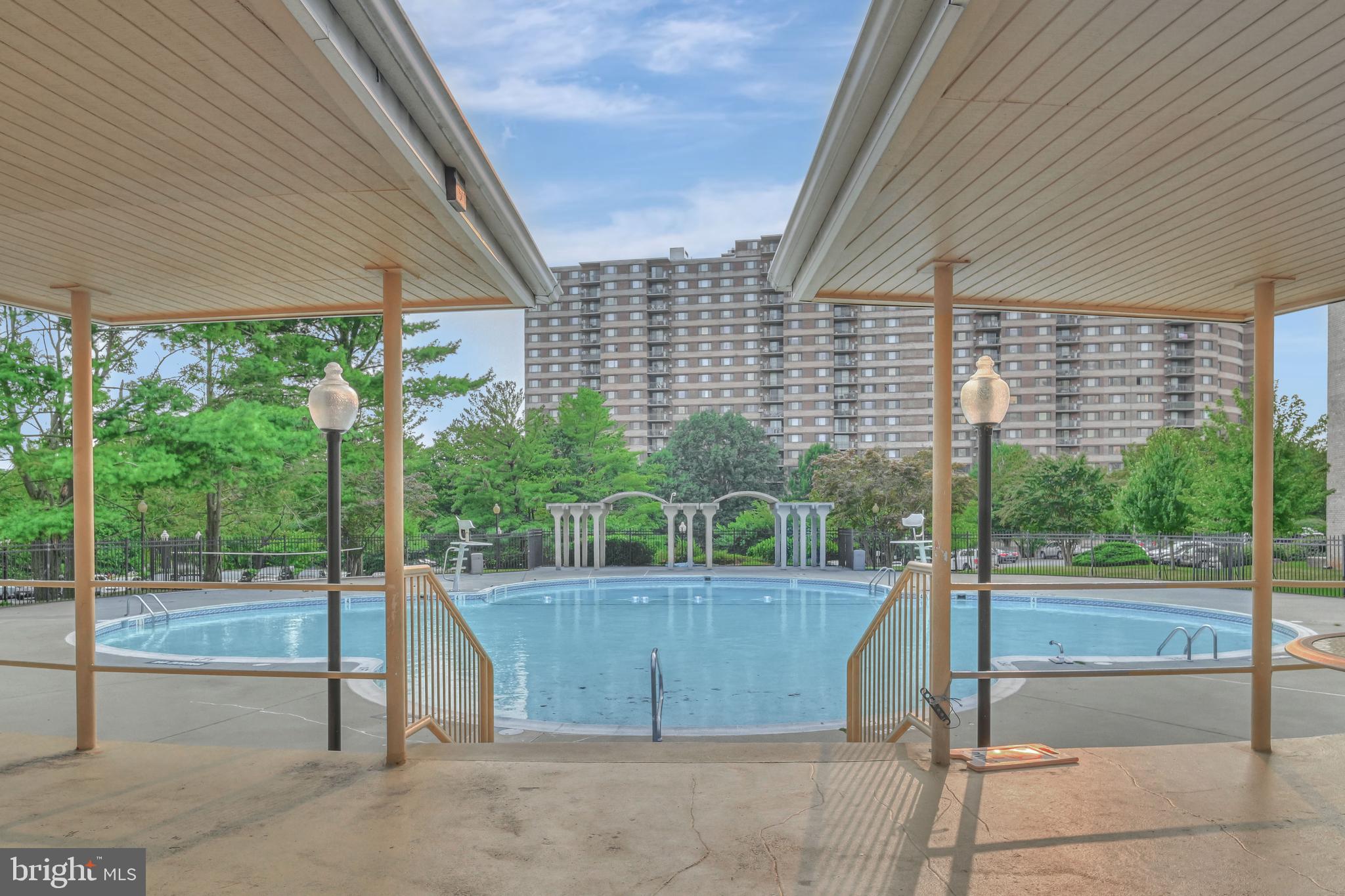 1111 University Boulevard West, Unit 611A Silver Spring, MD 20902 - Photo 24 of 26 a view of a swimming pool with a patio