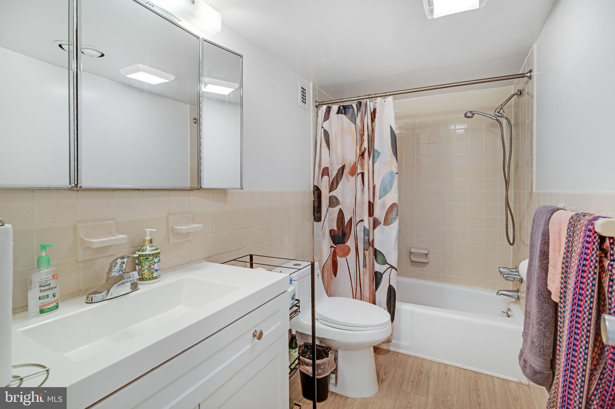 1111 University Boulevard West, Unit 611A Silver Spring, MD 20902 - Photo 5 of 26 a bathroom with a sink toilet and shower