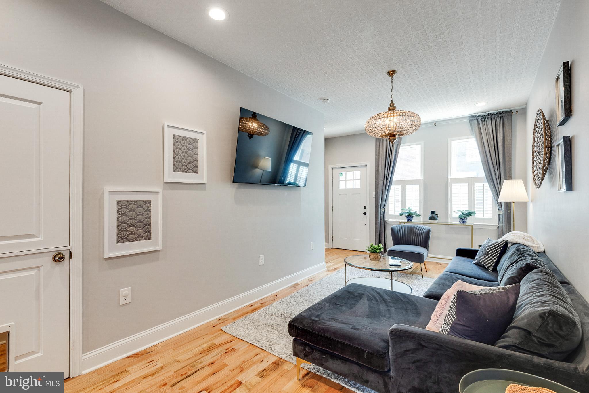 1935 Cambridge Street Philadelphia, PA 19130 - Photo 11 of 54 a living room with furniture a window and a chandelier