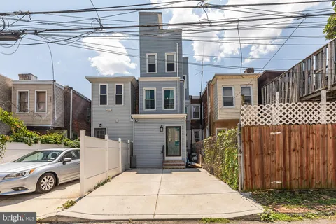 a view of a house with a wooden fence