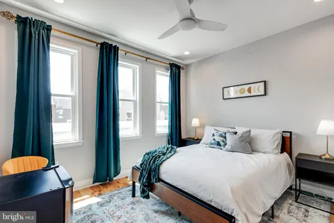 a bathroom with a sink vanity mirror and toilet