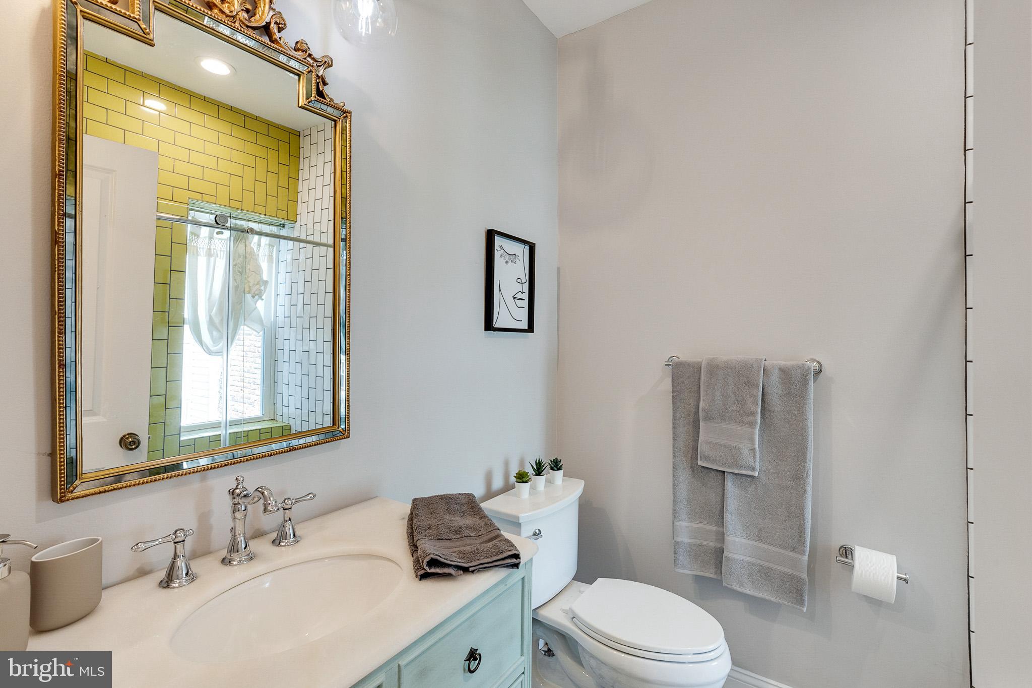 1935 Cambridge Street Philadelphia, PA 19130 - Photo 22 of 54 a bathroom with a sink vanity mirror and toilet