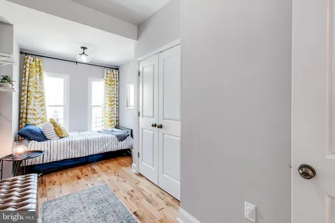 an empty room with wooden floor and sliding door