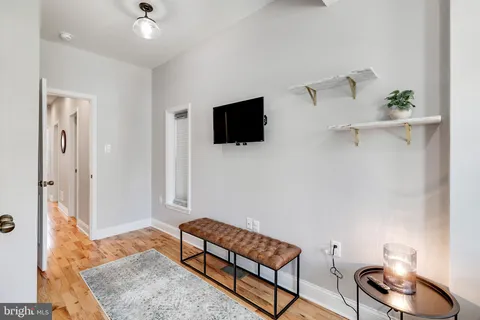 a view of an empty room and wooden floor
