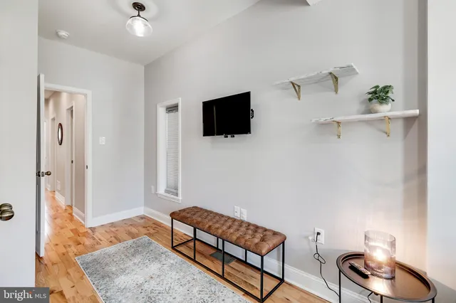 a view of an empty room and wooden floor
