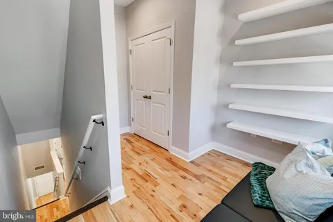 a bedroom with a bed and a painting on the wall