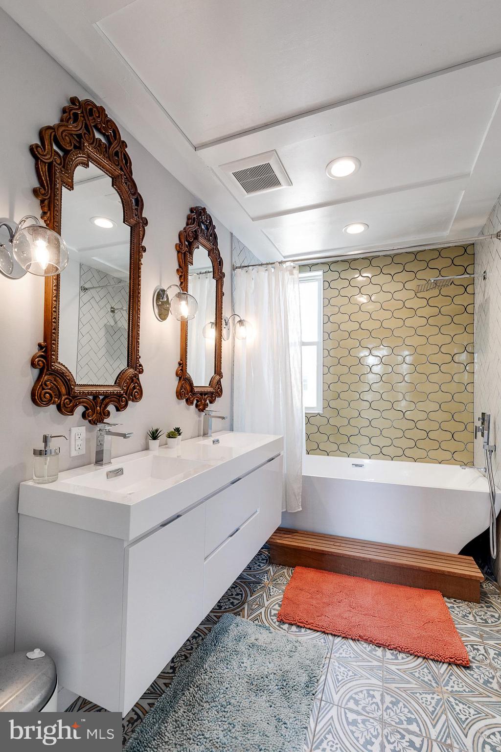 1935 Cambridge Street Philadelphia, PA 19130 - Photo 33 of 54 a bathroom with a bathtub sink and mirror