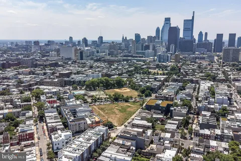an aerial view of a city with tall buildings