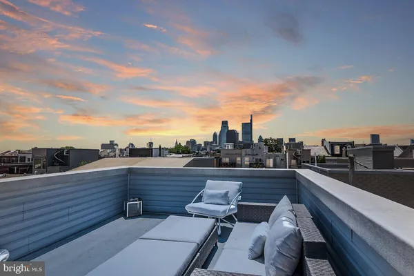 a living room with furniture a chandelier and a large mirror