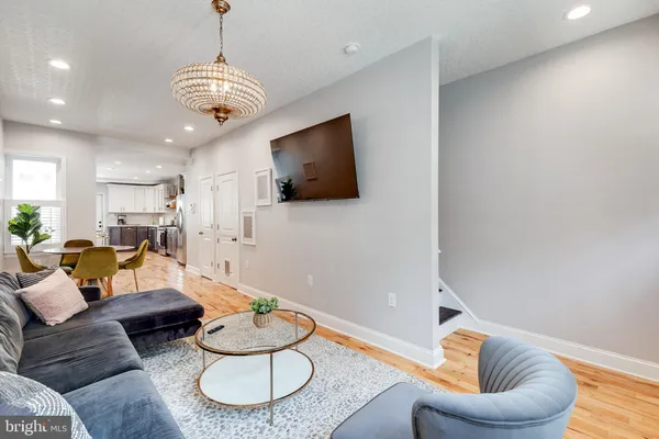 a living room with furniture and a chandelier