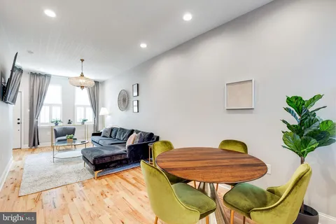 a large kitchen with stainless steel appliances kitchen island granite countertop a refrigerator and cabinets