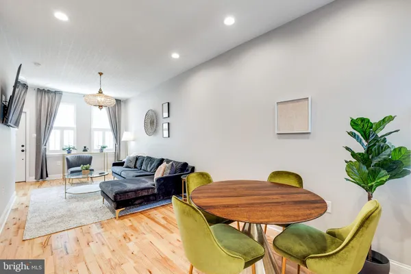 a large kitchen with stainless steel appliances kitchen island granite countertop a refrigerator and cabinets