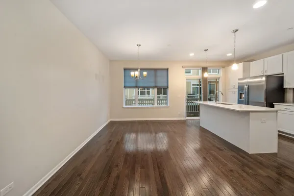 a view of kitchen with wooden floor and electronic appliances
