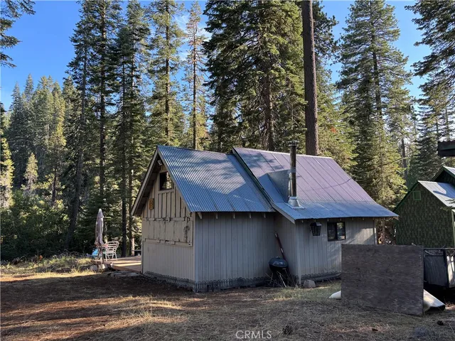 a view of a patio with table and chairs with wooden floor and fence