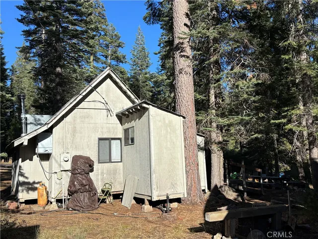 a couple of table and chairs in front of a house
