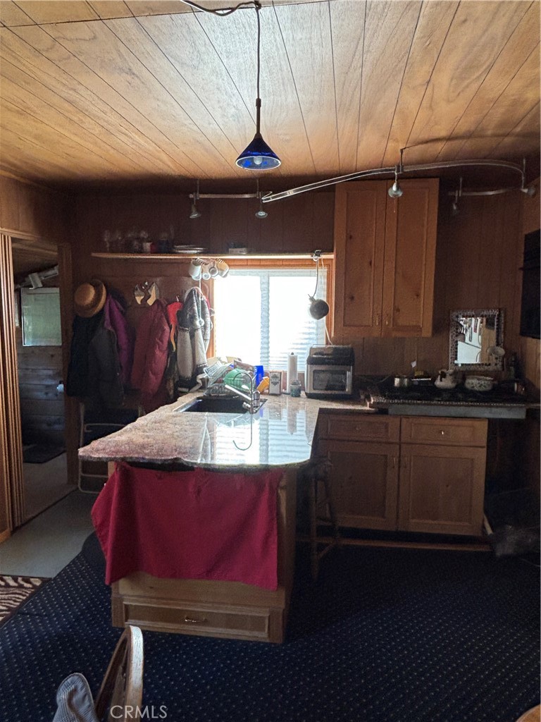 9478 Jones Creek Road, Unit 14 Forest Ranch, CA 95942 - Photo 7 of 35 a kitchen with kitchen island granite countertop a sink stainless steel appliances and cabinets