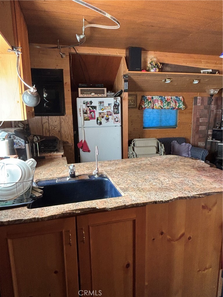 9478 Jones Creek Road, Unit 14 Forest Ranch, CA 95942 - Photo 8 of 35 a bathroom with a granite countertop sink and a mirror