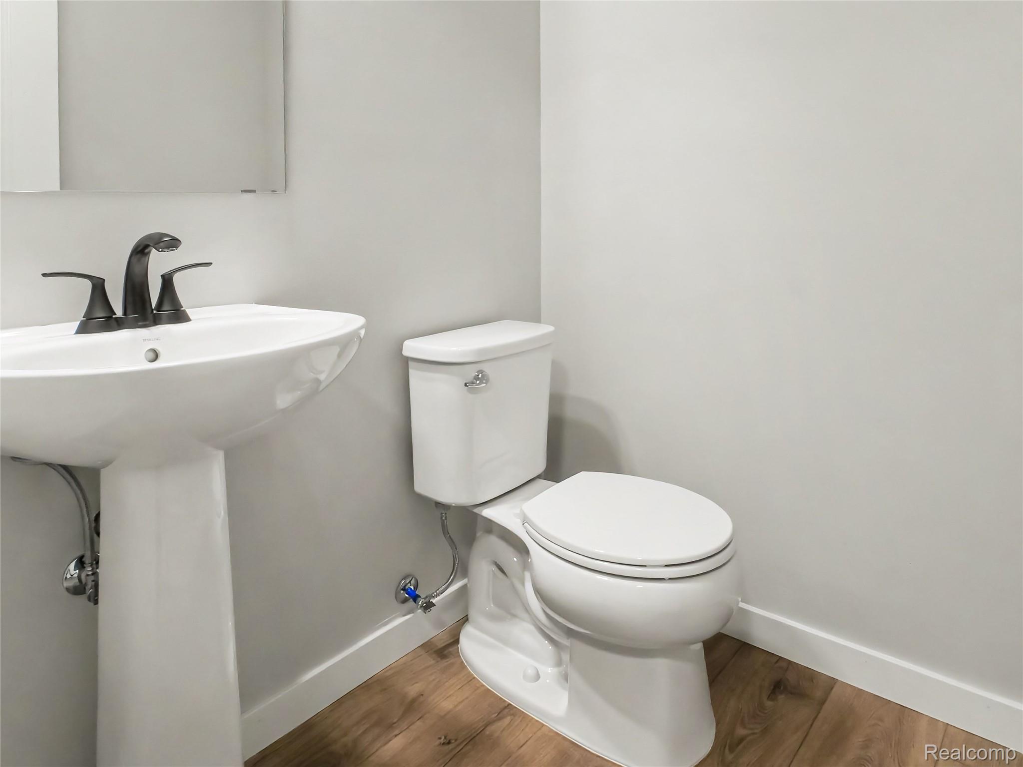 3185 Quail Ridge Court Clio, MI 48420 - Photo 7 of 35 First floor powder room is centrally located and easy for guests to use.