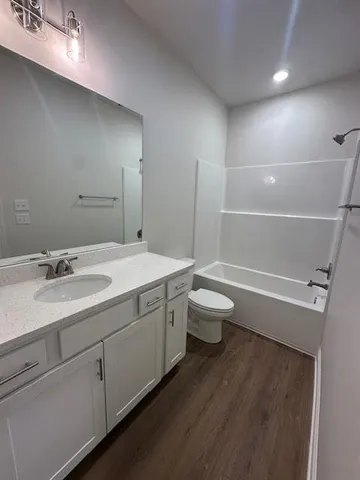 a bathroom with a double vanity sink toilet and shower