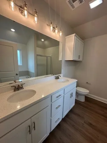 a bathroom with a double vanity sink and a mirror