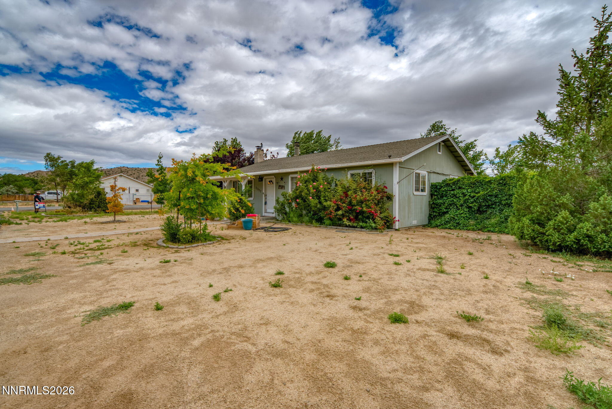 11577 Deodar Way Reno, NV 89506 - Photo 36 of 58 a view of a house with a dry plant in front of it