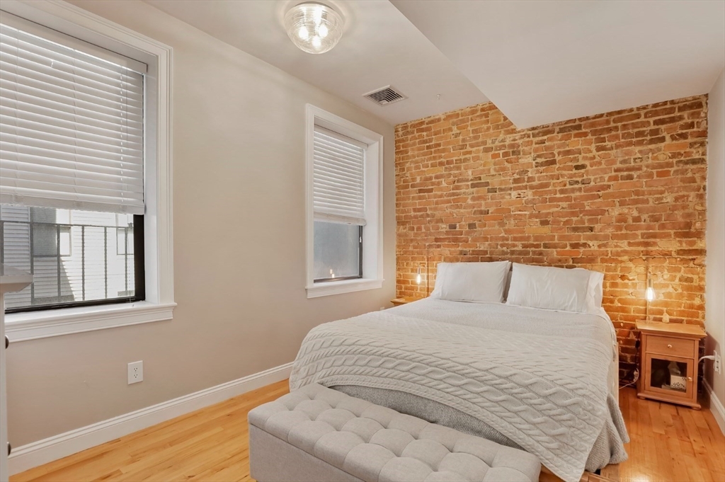 454 Hanover Street, Unit 4 Boston, MA 02113 - Photo 14 of 23 a bedroom with a bed and wooden floor