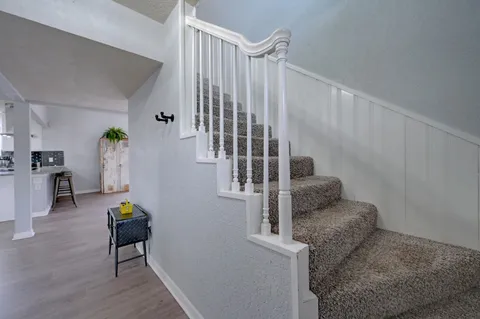 a bathroom with a granite countertop toilet sink and mirror