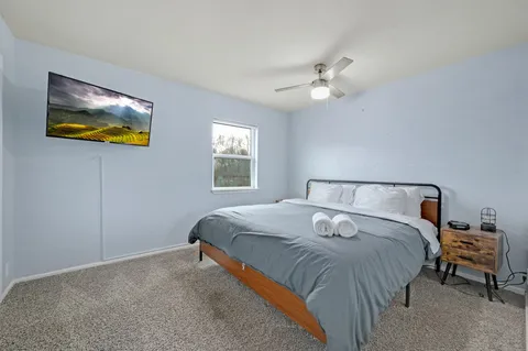 a bedroom with a bed and a window