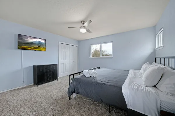 a bedroom with a bed and a chandelier