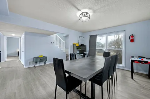 a view of a dining room with furniture and window