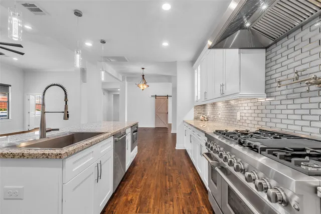 a kitchen with sink stove and cabinets