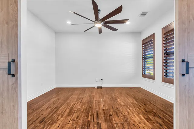 wooden floor in a room next to a window