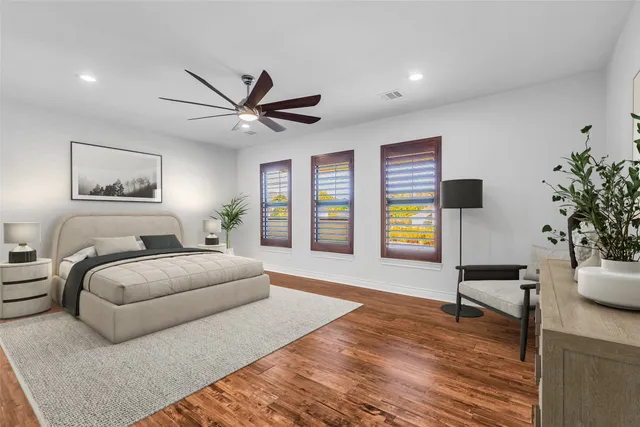 a spacious bedroom with a bed and a desk