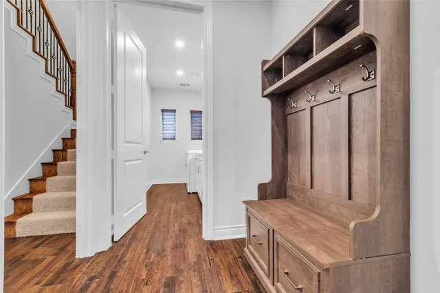 a view of an entryway with wooden floor