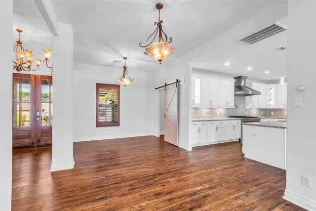 a view of a kitchen with wooden floor and a kitchen
