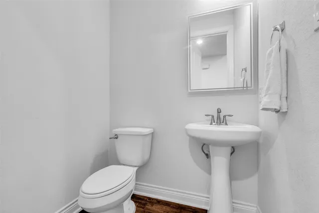 a bathroom with a sink toilet and mirror