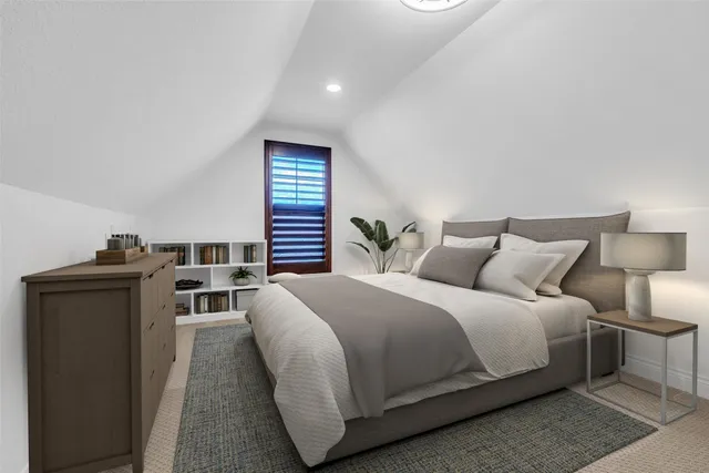 a large bedroom with bed and window